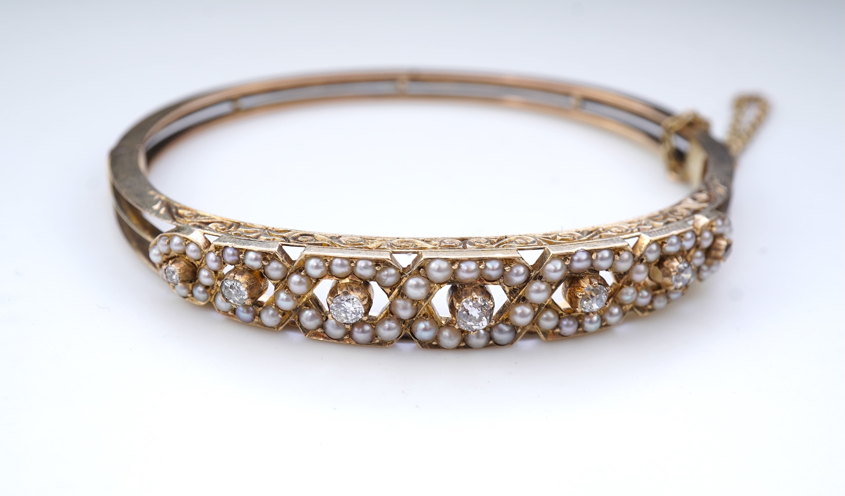 An Edwardian seed pearl and diamond bangle, early 20th century